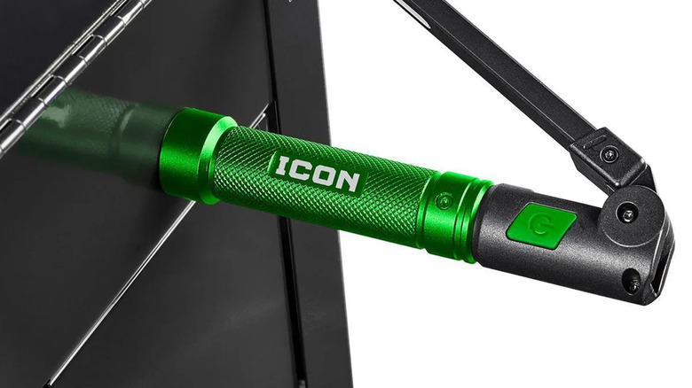 A green Icon brand work light affixed magnetically to a toolbox