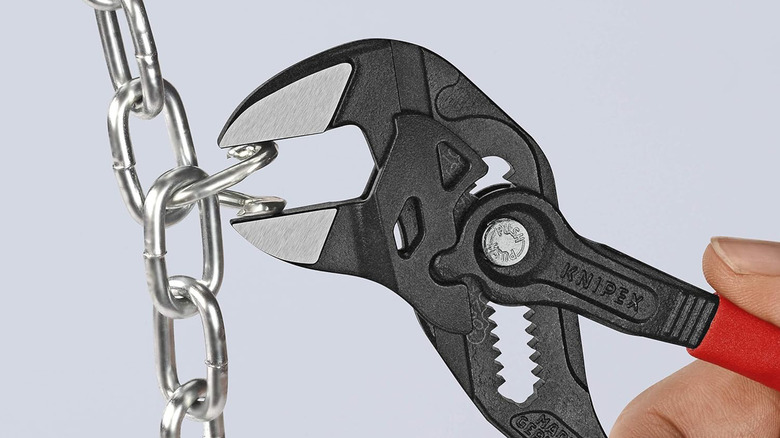 A pair of Knipex pliers bending a link in a chain