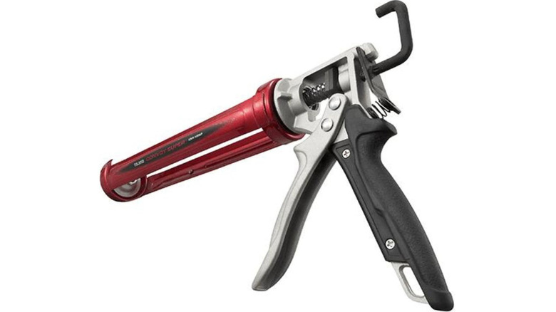 A Tajima brand caulk gun against a white background