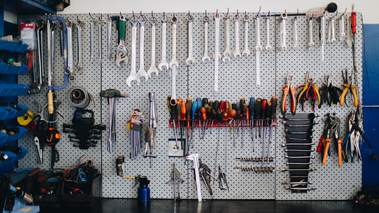 wrenches and other tools hanging on garage wall