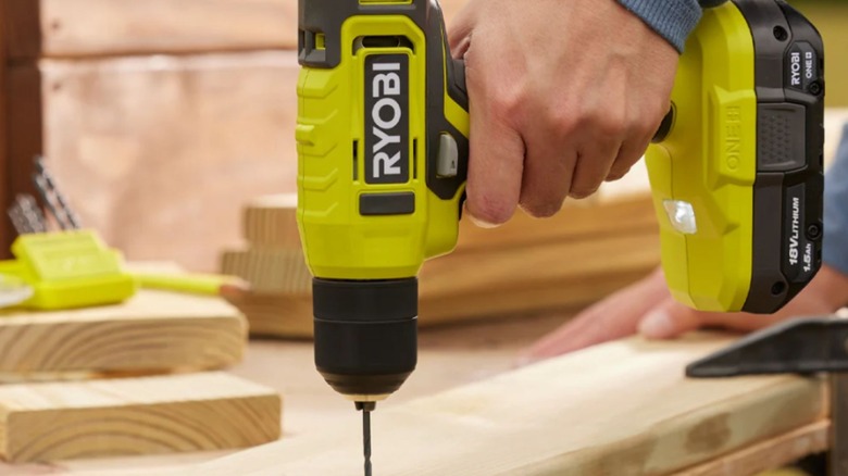 Man using Ryobi One+ 18V cordless drill