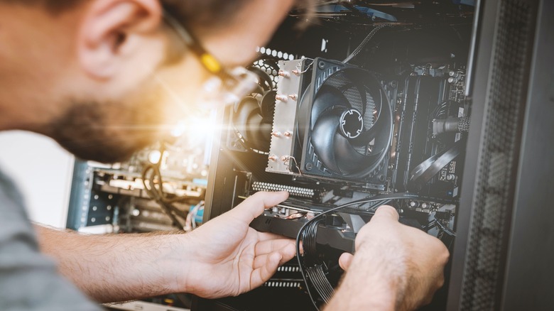 man building desktop computer tower
