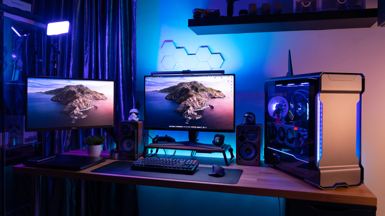 gaming pc setup including two monitors and a computer on a wooden desk