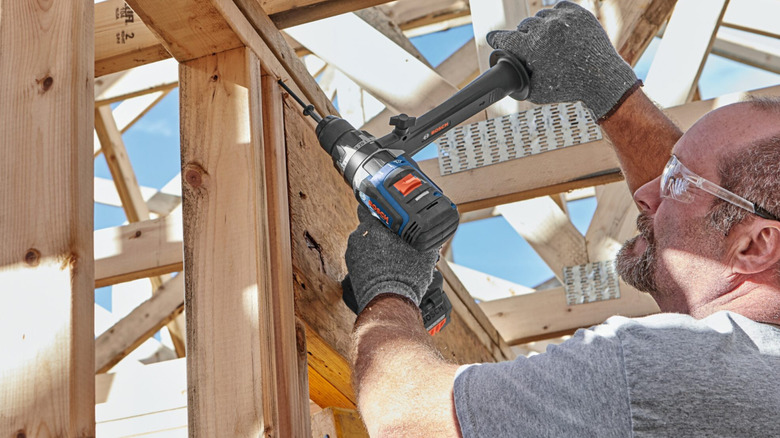 Drilling on jobsite with Bosch hammer drill.