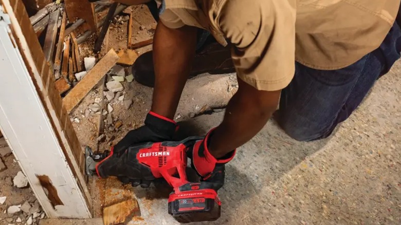 Person doing renovation with with Craftsman reciprocating saw.