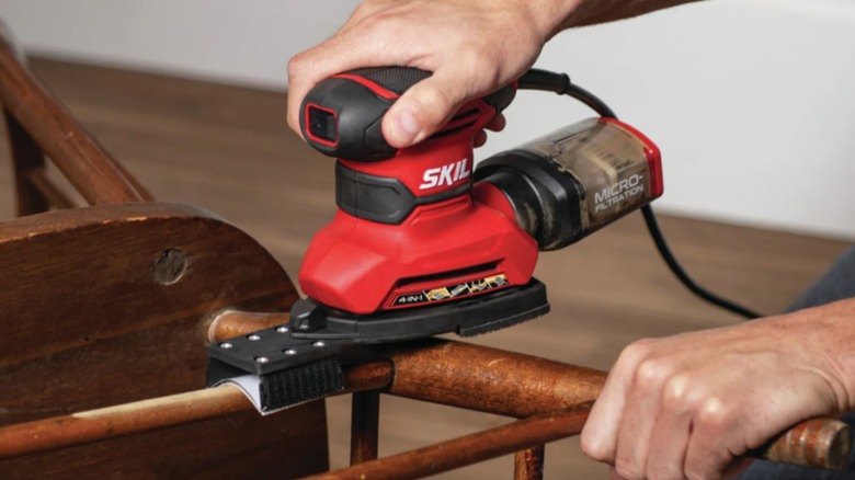 Sanding chair with Skil detail sander.
