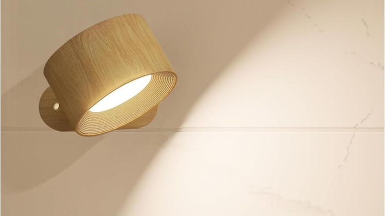 A Magnetic Wall Sconce facing downward with its light on