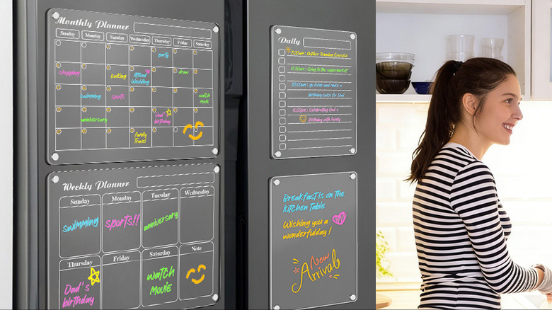Magnetic Calendars attached to a fridge in a kitchen.