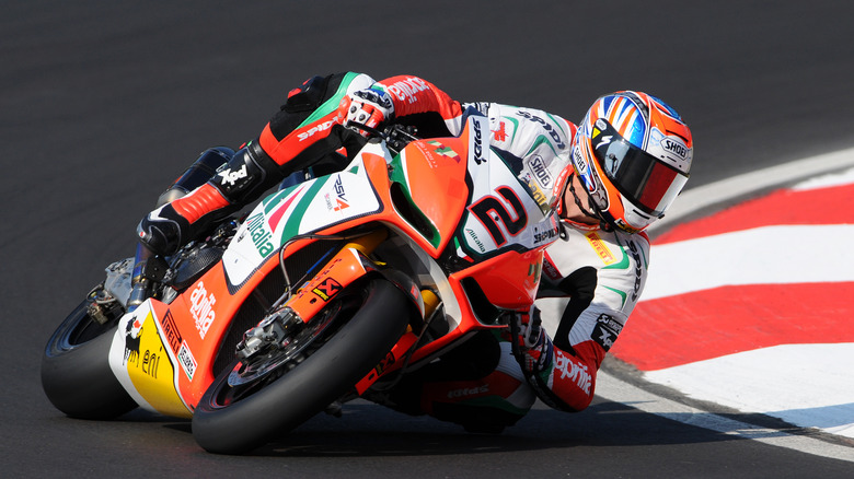 rider cornering on Aprilia RSV4 motorcycle