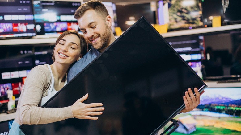 People hugging new tv