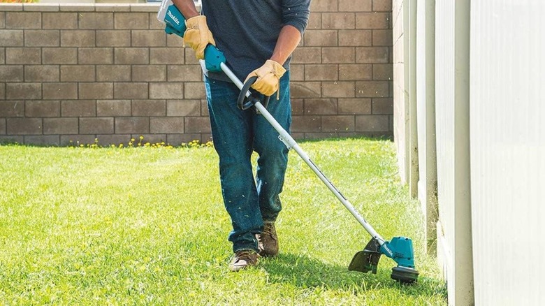 Man using Makita XRU23Z String Trimmer