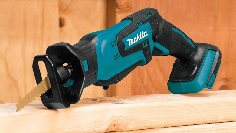 Makita XRJ01Z Reciprocating Saw balancing on wood plank