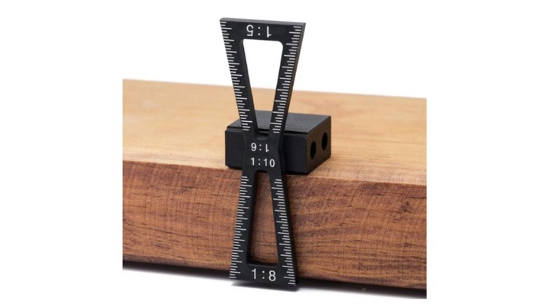 Black dovetail marker placed on wood