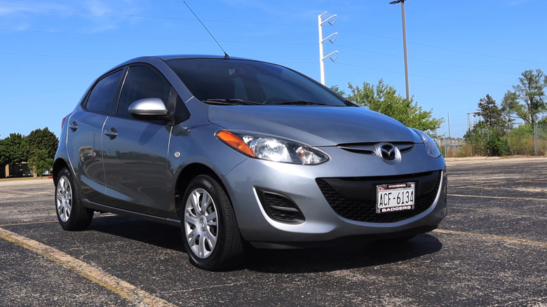 A silver 2014 Mazda2 parked