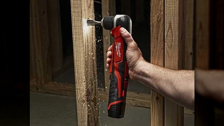 Using a right angle drill with an LED to work on a piece of wood.
