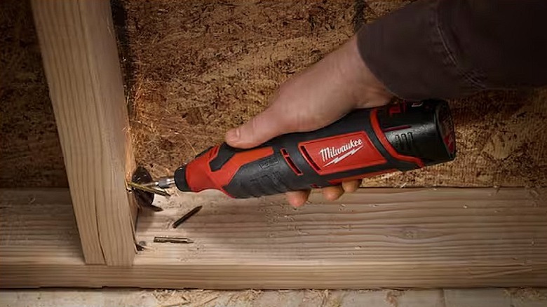 Removing nails from wood via a rotary tool.