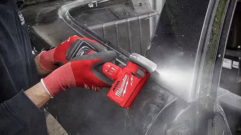 Using a cut off saw to cut metal.