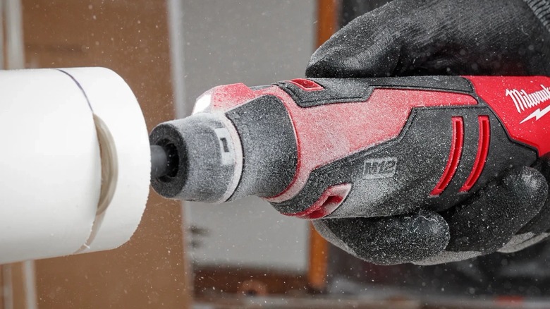 Person using Milwaukee rotary tool