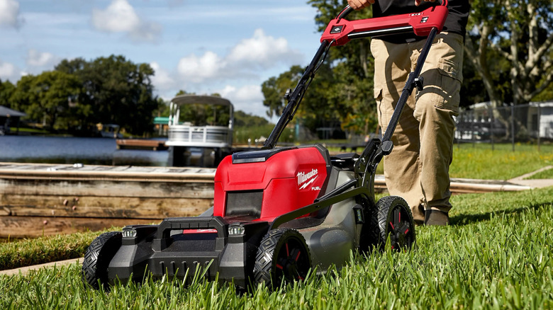 Person using Milwaukee powered mower