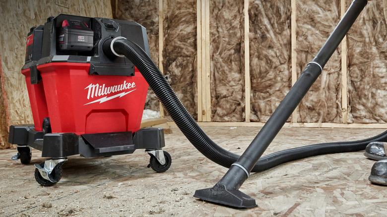 Person using Milwaukee vacuum
