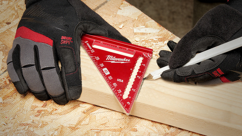 A close up of the Milwaukee 4-1/2 Inch Metal Trim Square being used on wood.