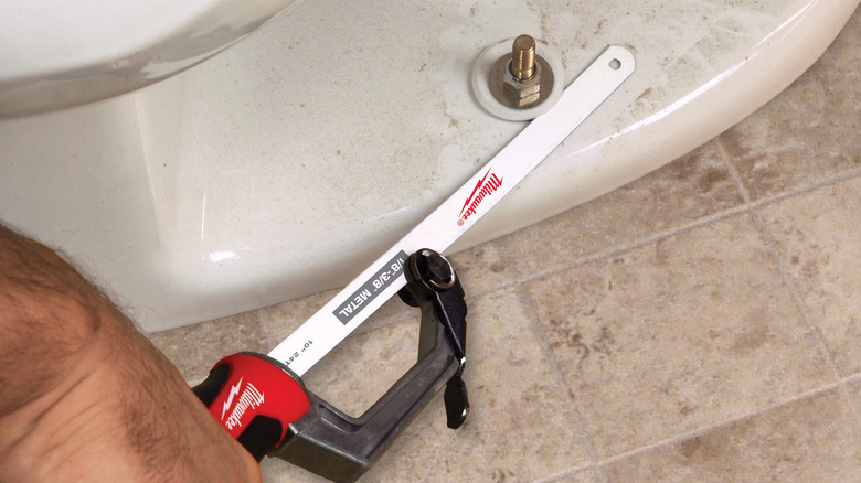 The Milwaukee Compact Hack Saw being used on a bolt.