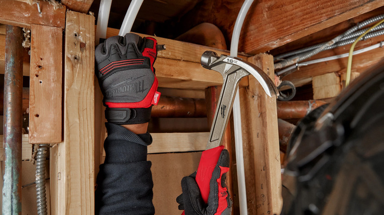 The Milwaukee Smooth Face Hammer being used on wood.