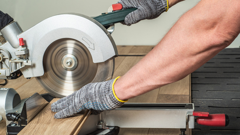 cutting with a miter saw while keeping hands in proper position