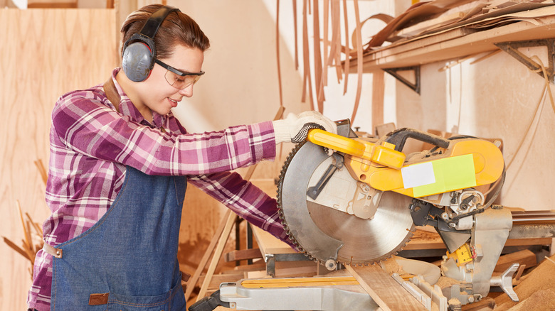 cutting with a miter saw while wearing protective equipment