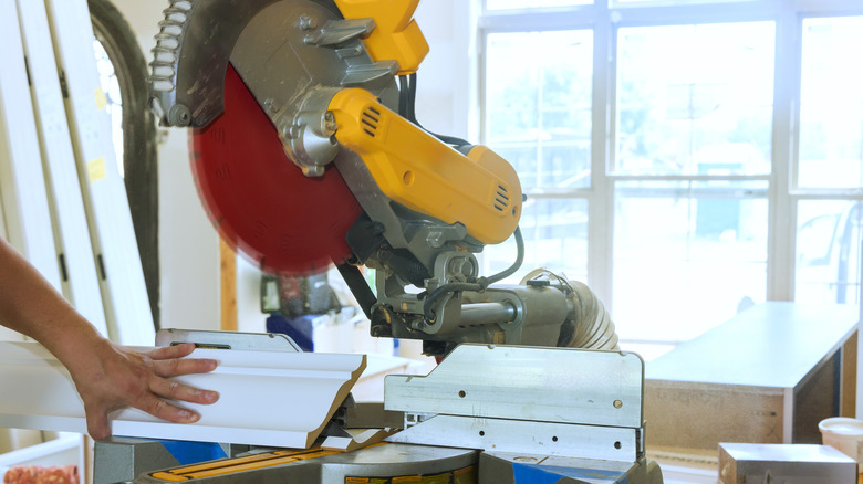 cutting trim piece at an angle with a miter saw jig