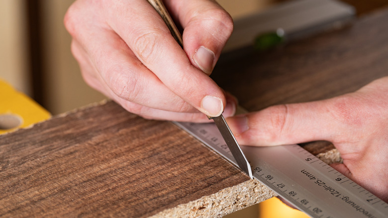 using a marking knife on a board