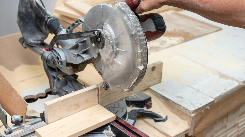 miter saw with backing board installed as a fence