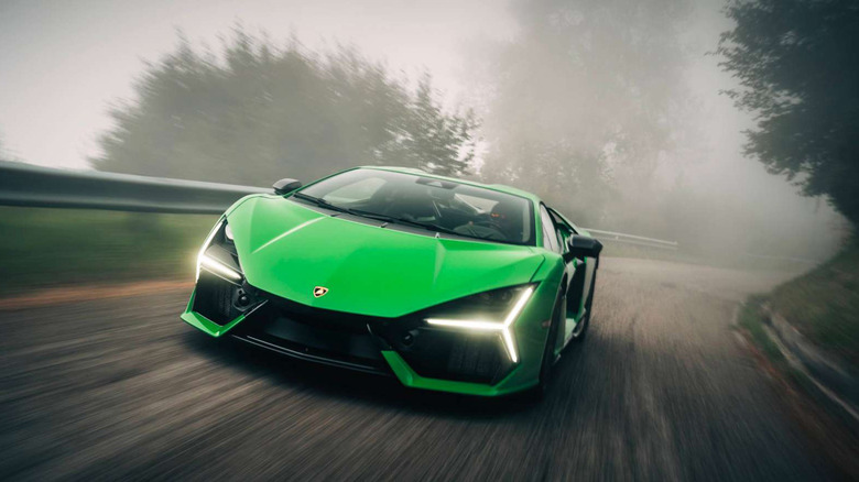 A green Lamborghini Revuelto driving through fog