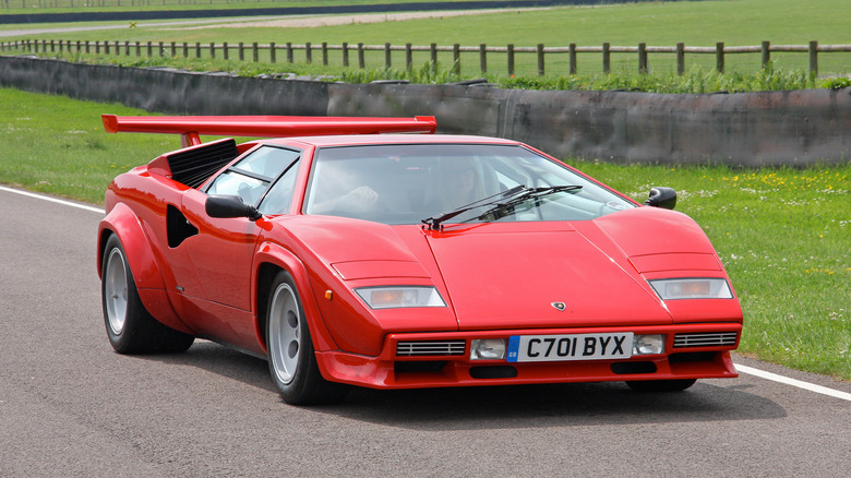 A red Lamborghini Countach on a country road