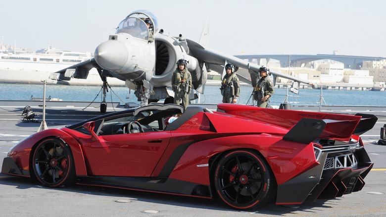 Lamborghini Veneno Roadster next to a jet