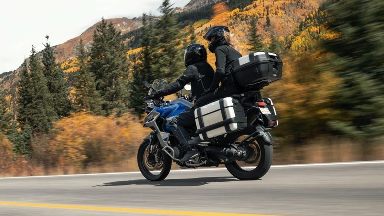 Triumph Tiger 1200 with two riders in the forest