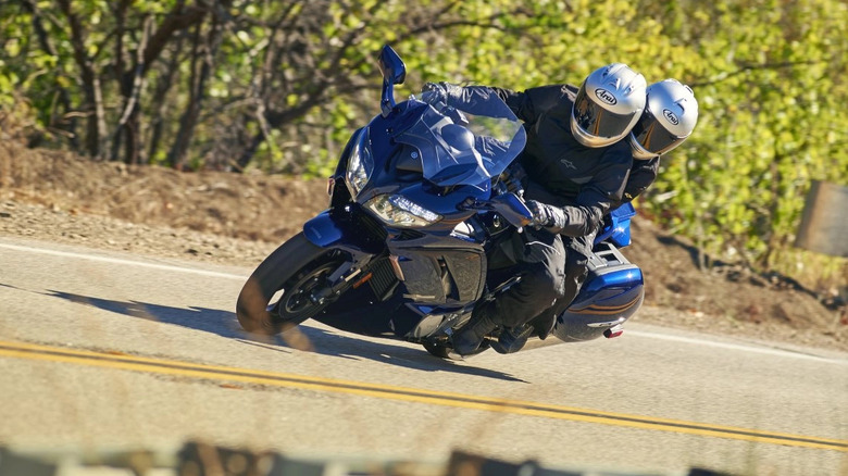 Yamaha FJR1300RS with two riders leaning through a corner