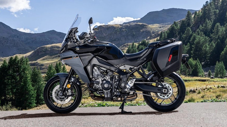 Yamaha Tracer 9 parked on its center stand in the mountains