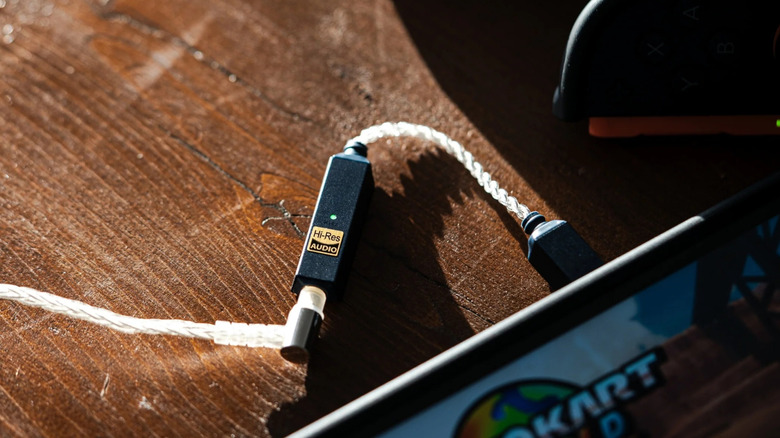 The iFi Go Link 2 plugged into a device and headphones