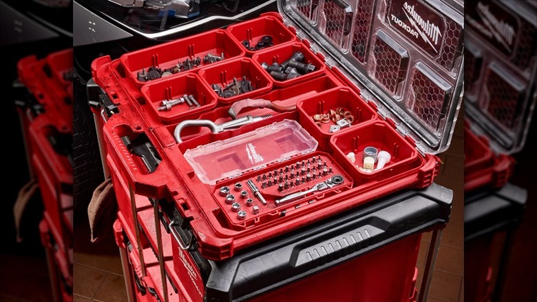 A Milwaukee Packout toolbox kit containing several small accessories and hand tools