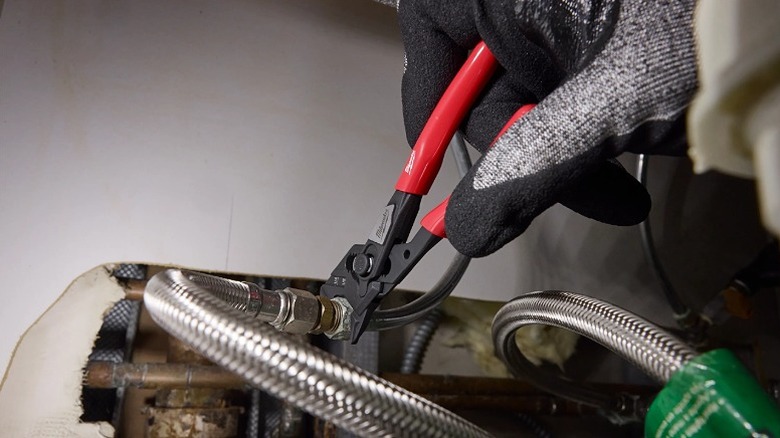 Using a mini wrench to work on bolts.