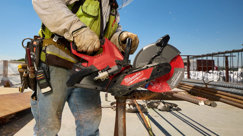 Contractor using a Milwaukee M18 Fuel cut-off saw to trim rebar
