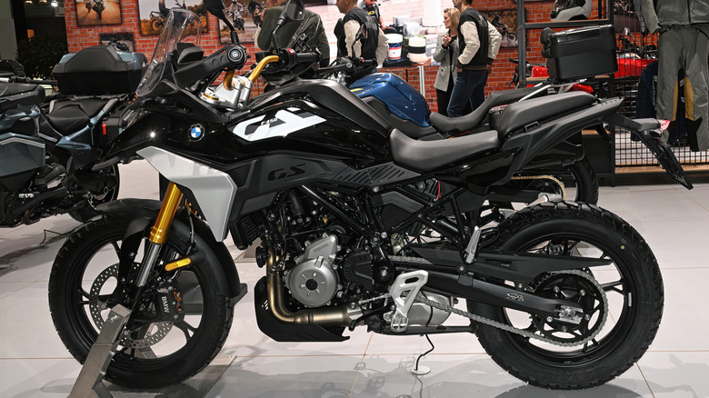 A black and silver BMW F450GS adventure bike on display at an indoors motor show in Brussels.