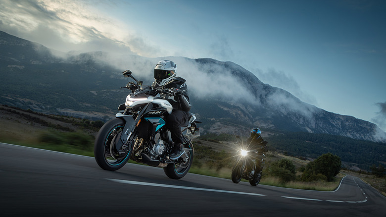 Two riders, one behind the other, in full gear and helmets, on CFmoto's new 675NK motorbikes.