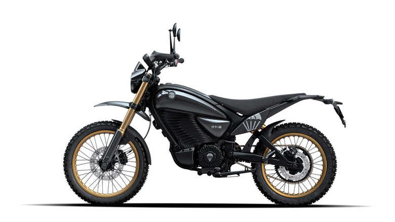 A black, gray, and gold Royal Enfield Flying Flea S6 scrambler electric bike on a white backdrop.
