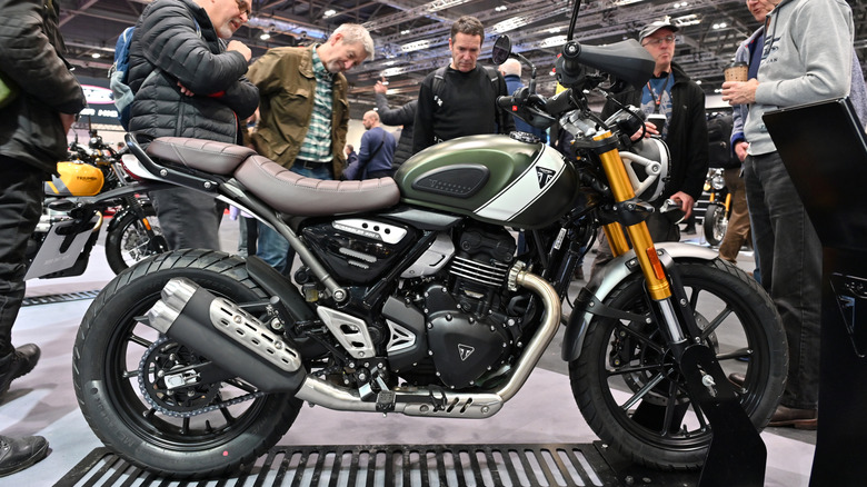 A Triumph Scrambler 400X motorbike on display at an indoor bike show, allegedly due to be replaced by a smaller, 350 cc platform.