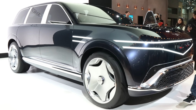 A black Genesis concept SUV that the GV90 EV will likely be based on, being shown at an auto show in 2024.