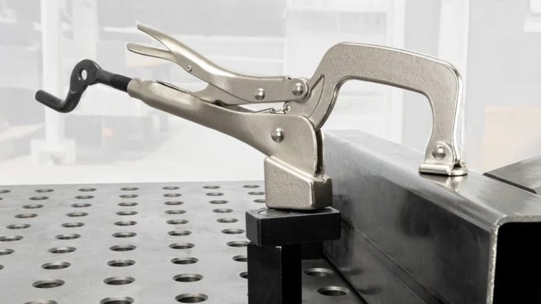 Fireball Tool's bulldog swivel plier attached to a fixture table