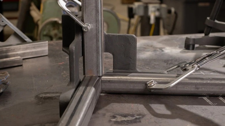 Fireball Tool's three-axis square clamped to some metal beams on a workstation