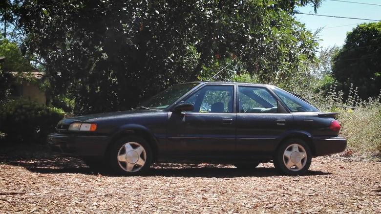 A black 1991 Geo Prizm Parked